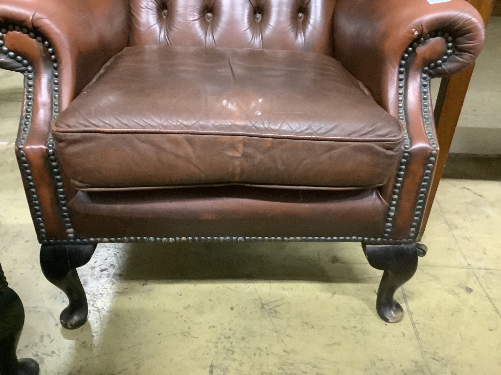 A pair of buttoned burgundy leather wing armchairs, width 86cm, depth 80cm, height 110cm